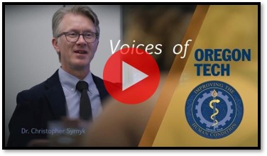 A YouTube thumbnail of a man in a suit and tie being interviewed in an office.