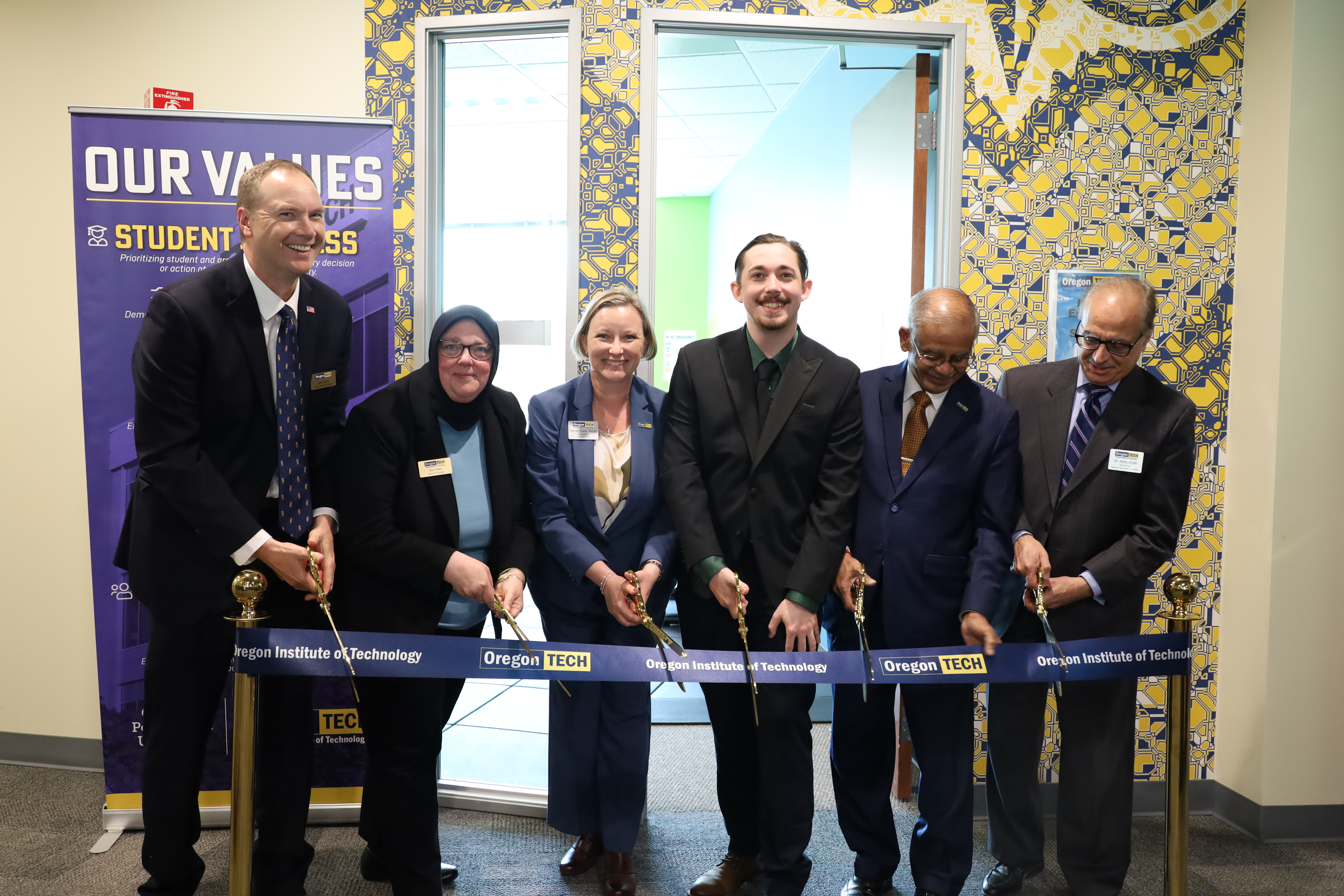 A group of leaders cut the ribbon to open the PM Fitness Center April 8 2026.
