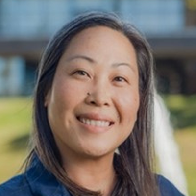 Image of Emy Martin with shoulder length dark hair and navy shirt