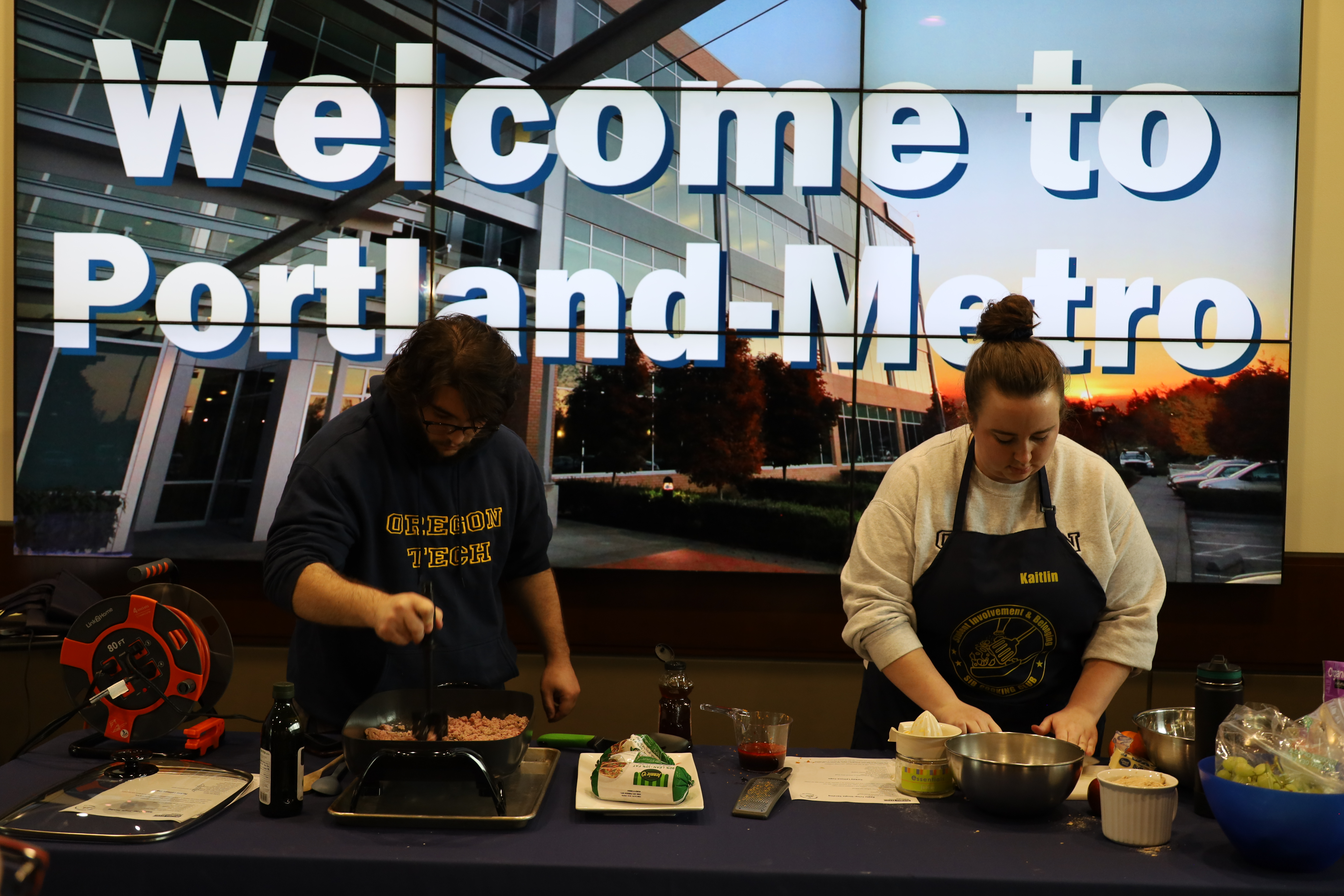 Two students enjoy a cooking demonstration and meal at Student Involvement and Belonging's Cooking Club event during the summer of 2025.