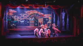 Performers on stage dancing