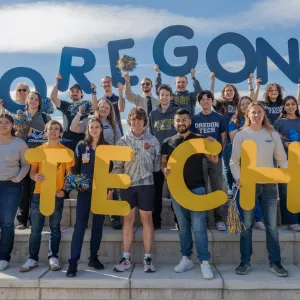 Students holding up Oregon Tech letters