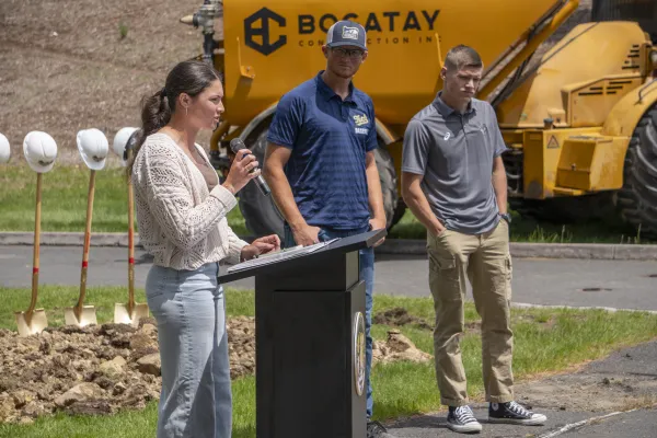 Malia Mick speaking at a podium