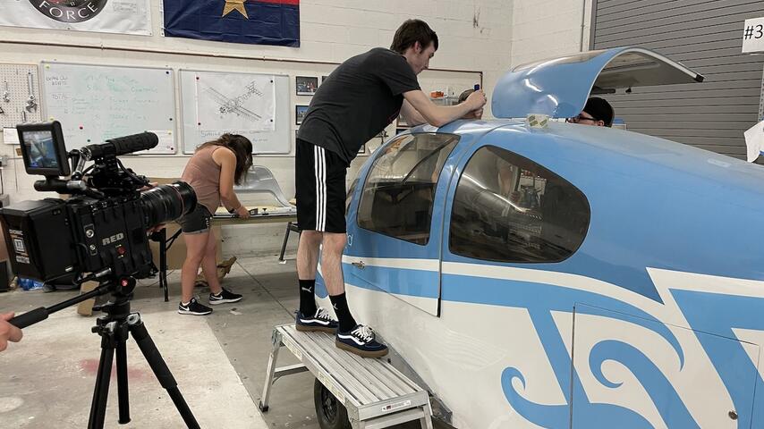 Students installing the door to the plane.
