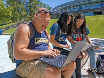 Students studying outside by Fountain